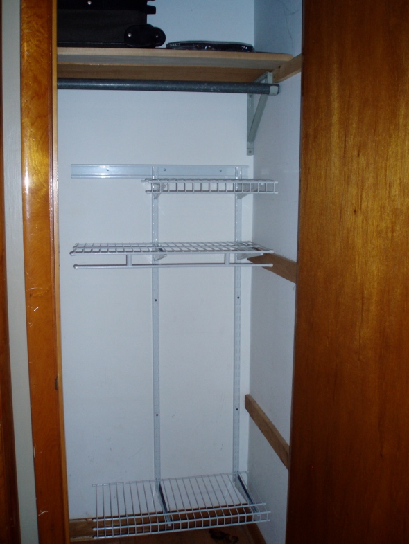 Note:  One wooden shelf in the top of the closet and only three wire shelves remain.