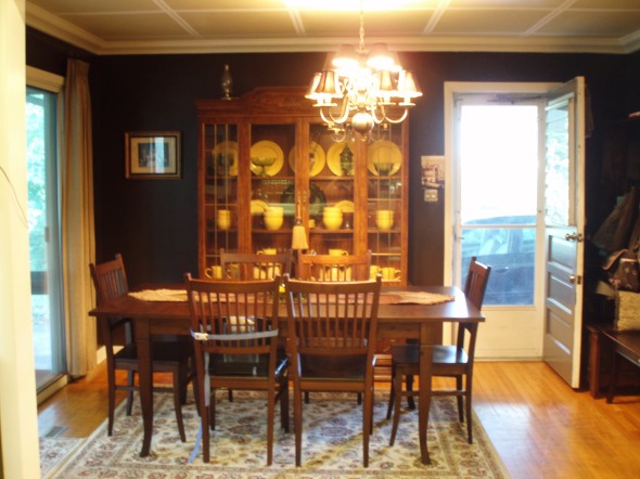 Just a coat of dark, brown paint; some creative, faux painting on the ceiling; adding crown molding and painting all of the trim white; and our furnishings made it much better, without much of a budget.